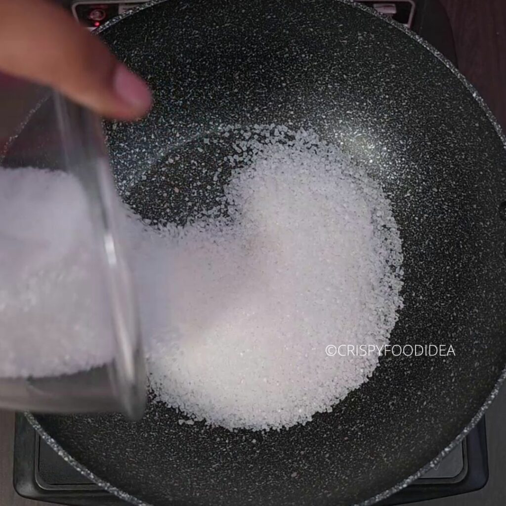 Add sugar into the wok to make syrup for Aam Panna