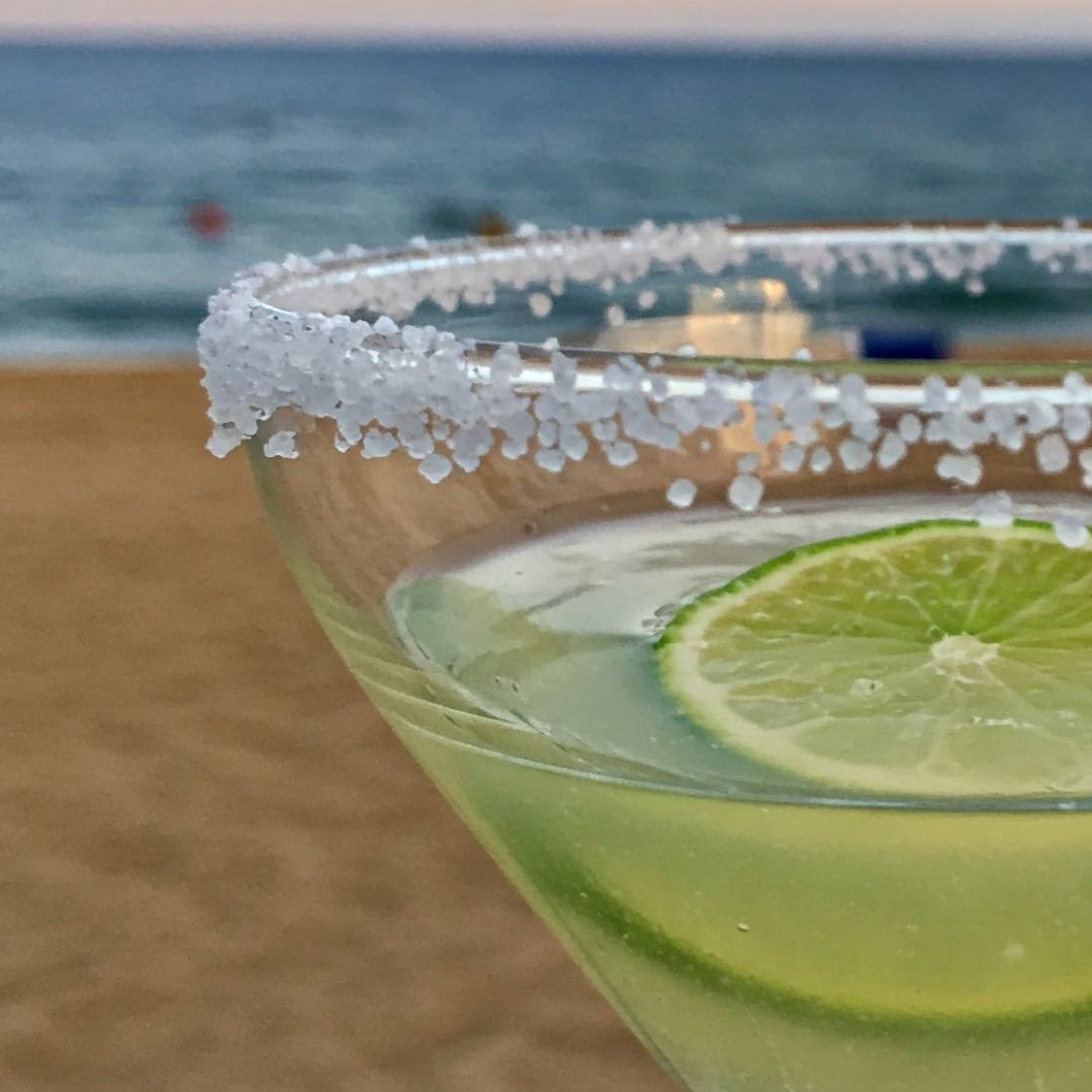 Rimming margarita glass with lime and salt