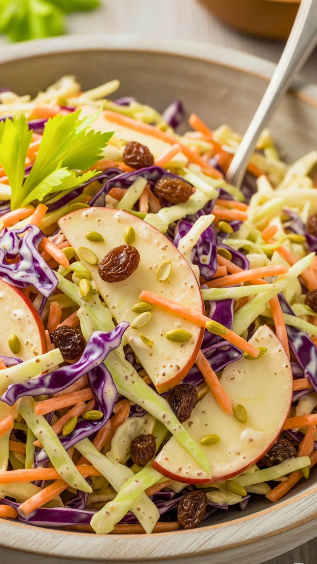 Apple and raisin creamy coleslaw with celery seed