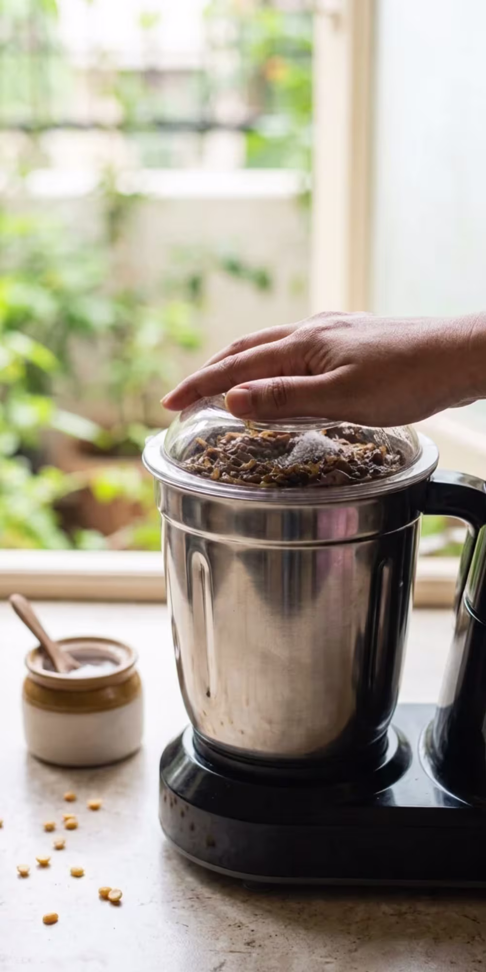 Thick red onion chutney being blended in a mixer grinder for serving with dosa and idli
